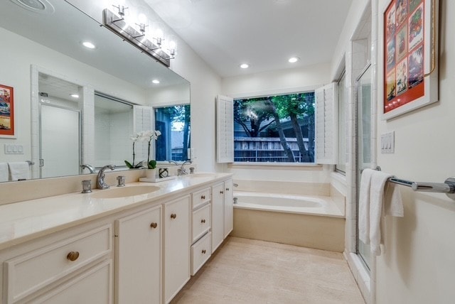 9616 Viewside Dr, Dallas, TX 75231 - full bath with double vanity, a garden tub, recessed lighting, and an enclosed shower