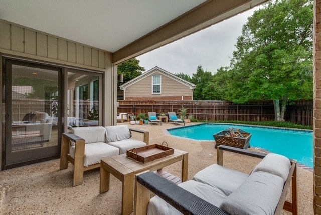 9616 Viewside Dr, Dallas, TX 75231 - view of swimming pool featuring a patio, a fenced backyard, and an outdoor living space with a fire pit