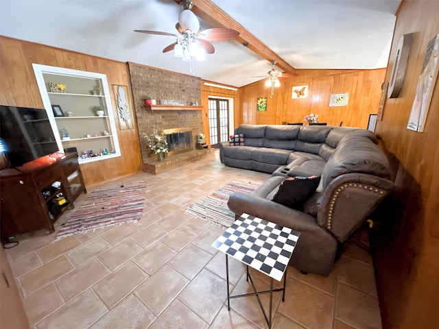 107 W Bayside Dr, Mabank, TX 75156 - tiled living area with wooden walls, ceiling fan, and a fireplace