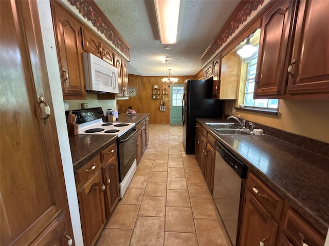 107 W Bayside Dr, Mabank, TX 75156 - kitchen featuring white microwave, range with electric cooktop, stainless steel dishwasher, a sink, and dark countertops