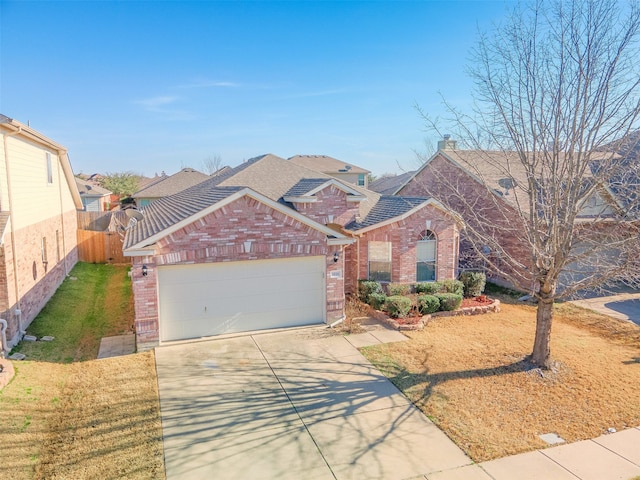 1016 Camp Verde Dr, Forney, TX 75126 - view of front of house with brick siding, driveway, a garage, and roof with shingles