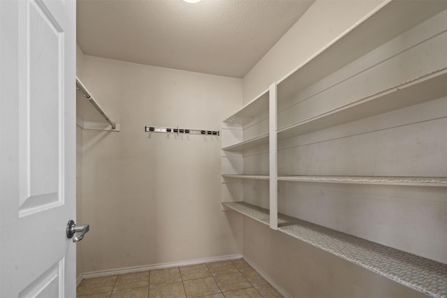 1016 Camp Verde Dr, Forney, TX 75126 - spacious closet featuring light tile patterned flooring