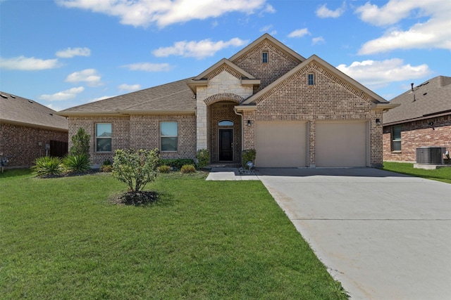 3640 Twin Pines Dr, Grand Prairie, TX 76065 - french provincial home featuring a garage, central AC unit, brick siding, and concrete driveway