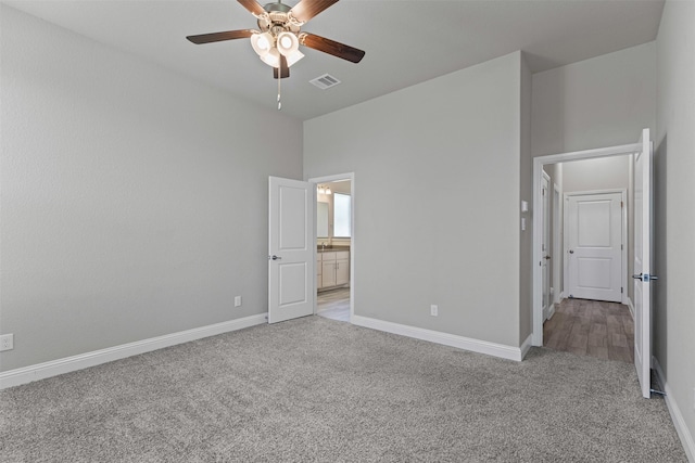 3640 Twin Pines Dr, Grand Prairie, TX 76065 - unfurnished bedroom with light colored carpet, baseboards, ensuite bathroom, and ceiling fan