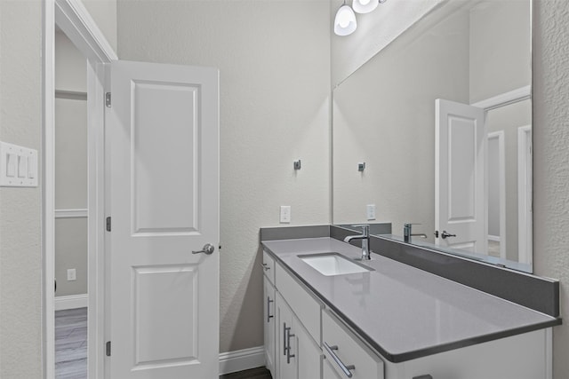 3640 Twin Pines Dr, Grand Prairie, TX 76065 - bathroom with vanity, a textured wall, and wood finished floors