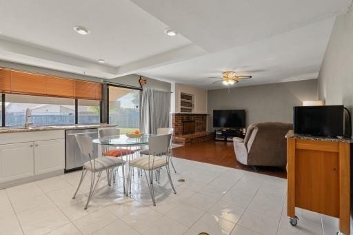 4028 Engleman St, Fort Worth, TX 76137 - dining space featuring ceiling fan, a fireplace, light tile patterned floors, and recessed lighting