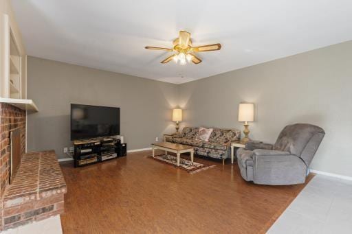 4028 Engleman St, Fort Worth, TX 76137 - living room with a ceiling fan, a brick fireplace, and baseboards