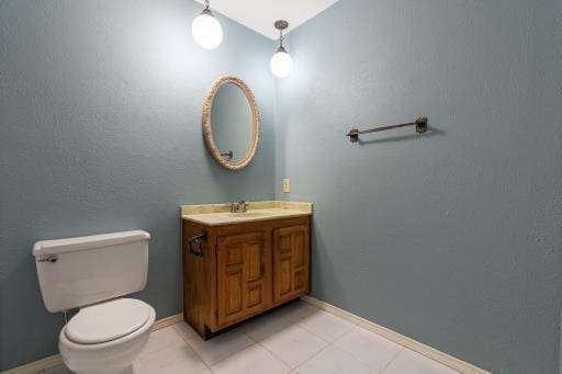 4028 Engleman St, Fort Worth, TX 76137 - bathroom with vanity, toilet, baseboards, and tile patterned flooring