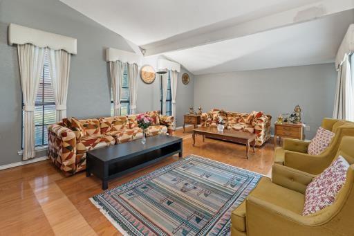 4028 Engleman St, Fort Worth, TX 76137 - living room featuring vaulted ceiling, wood finished floors, and baseboards