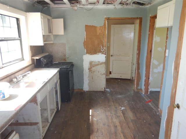 7519 Henderson Gin Rd, Shreveport, LA 71107 - kitchen with washer / dryer, hardwood / wood-style floors, and white cabinets
