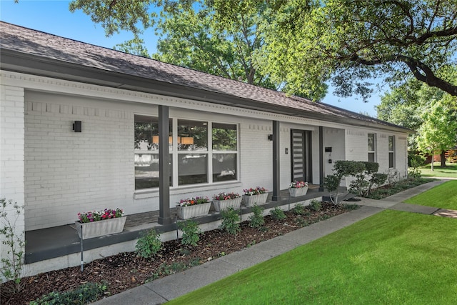 9918 Ila Dr, Dallas, TX 75220 - view of front facade with brick siding, a porch, a front lawn, and a shingled roof