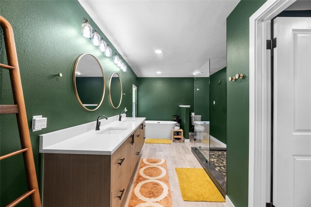 9918 Ila Dr, Dallas, TX 75220 - full bathroom with a freestanding bath, double vanity, toilet, and a bidet