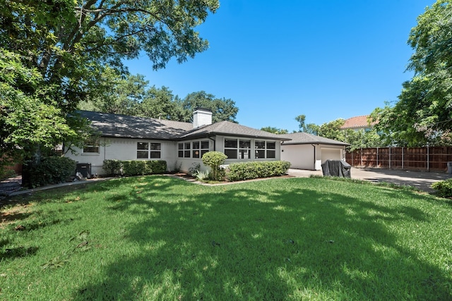 9918 Ila Dr, Dallas, TX 75220 - back of house with an attached garage, a chimney, and driveway