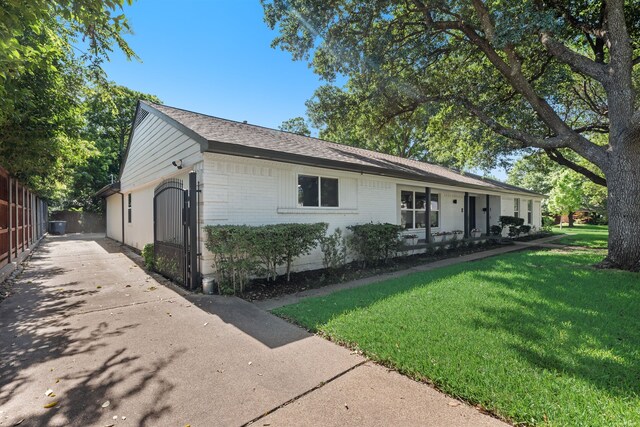 9918 Ila Dr, Dallas, TX 75220 - view of front of property with brick siding, a shingled roof, and concrete driveway