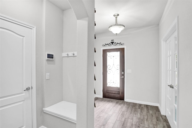 1135 Saddle Ridge Dr, Aubrey, TX 76227 - entrance foyer with arched walkways, light wood-type flooring, and baseboards