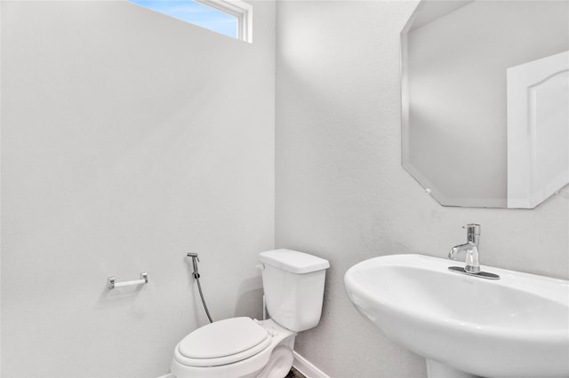 1135 Saddle Ridge Dr, Aubrey, TX 76227 - half bath with a sink, toilet, and baseboards