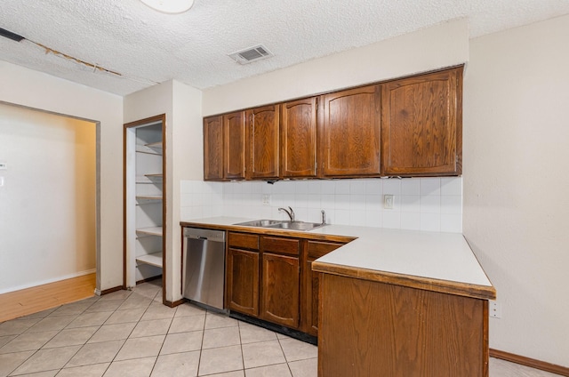 1824 Angelina Dr, Garland, TX 75040 - kitchen with dishwasher, a sink, decorative backsplash, light countertops, and a textured ceiling