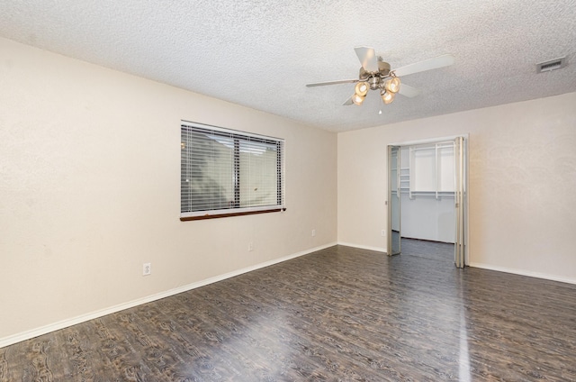 1824 Angelina Dr, Garland, TX 75040 - spare room with ceiling fan, dark wood finished floors, a textured ceiling, and baseboards