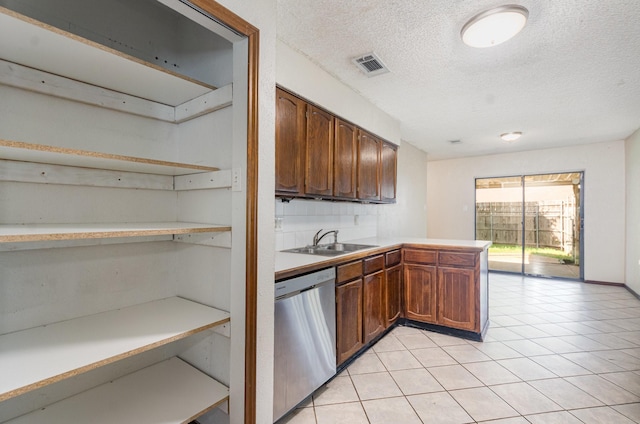 1824 Angelina Dr, Garland, TX 75040 - kitchen featuring stainless steel dishwasher, open shelves, a sink, a textured ceiling, and a peninsula