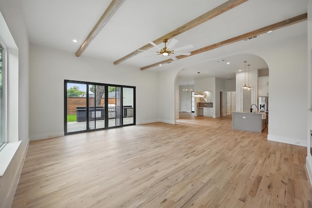 1224 S Pine St, Grapevine, TX 76051 - unfurnished living room with arched walkways, beam ceiling, light wood-style floors, a ceiling fan, and recessed lighting