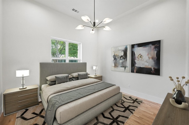 1224 S Pine St, Grapevine, TX 76051 - bedroom with a chandelier, wood finished floors, and baseboards