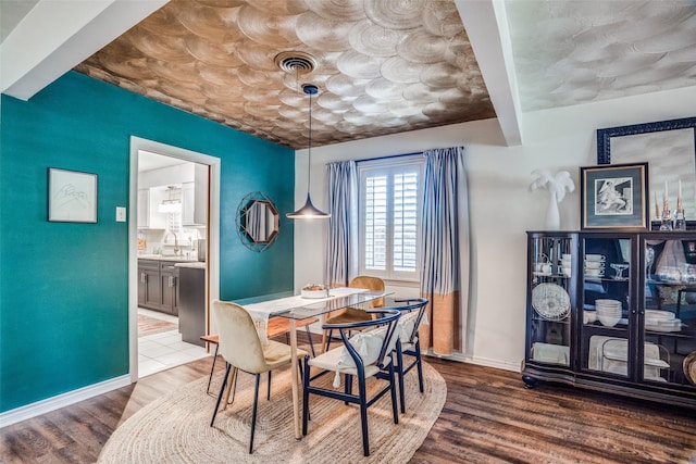 10542 Vinemont St, Dallas, TX 75218 - dining space featuring wood finished floors and baseboards