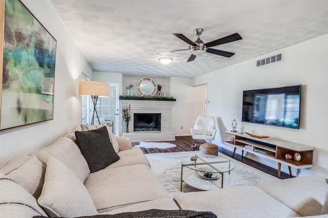 10542 Vinemont St, Dallas, TX 75218 - living area featuring wood finished floors, ceiling fan, and a fireplace