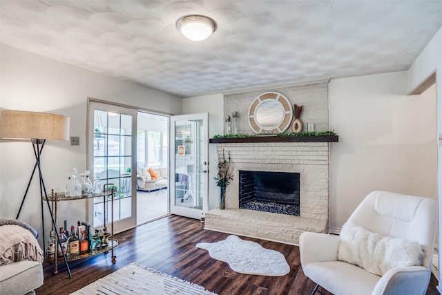 10542 Vinemont St, Dallas, TX 75218 - living area featuring wood finished floors and a brick fireplace