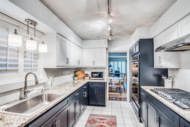 10542 Vinemont St, Dallas, TX 75218 - kitchen featuring a sink, appliances with stainless steel finishes, white cabinets, and backsplash