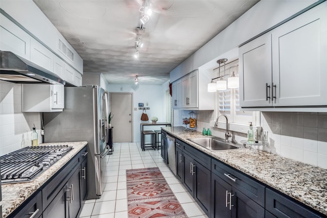 10542 Vinemont St, Dallas, TX 75218 - kitchen featuring a sink, appliances with stainless steel finishes, decorative backsplash, and wall chimney range hood