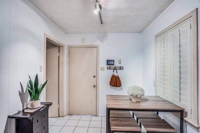10542 Vinemont St, Dallas, TX 75218 - entryway featuring light tile patterned floors, ornamental molding, and rail lighting