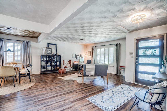 10542 Vinemont St, Dallas, TX 75218 - living room featuring healthy amount of natural light, wood finished floors, baseboards, and a chandelier