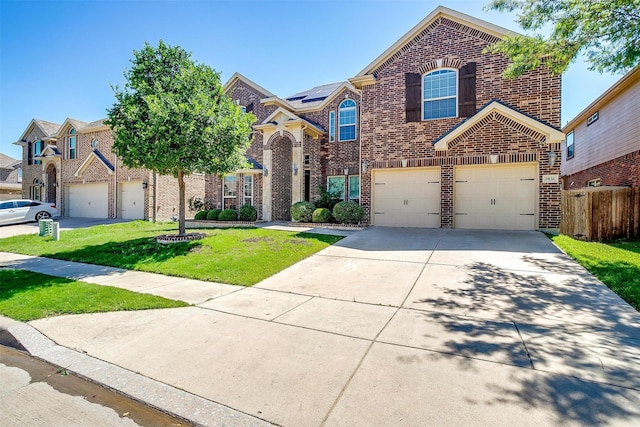 9836 Amaranth Dr, Fort Worth, TX 76177 - traditional-style house with brick siding, an attached garage, concrete driveway, and roof mounted solar panels