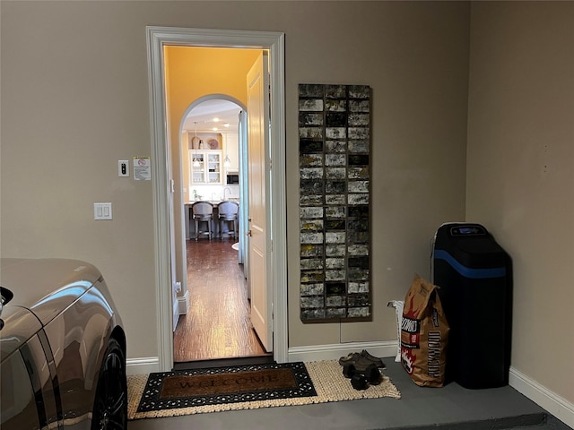 809 Cameron Ct, Coppell, TX 75019 - corridor with arched walkways, baseboards, and wood finished floors