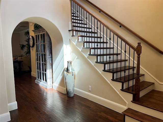 809 Cameron Ct, Coppell, TX 75019 - stairs featuring arched walkways, baseboards, and wood finished floors