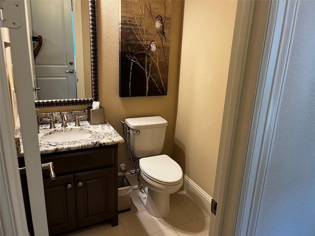 809 Cameron Ct, Coppell, TX 75019 - half bath with tile patterned flooring, vanity, toilet, baseboards, and a textured wall
