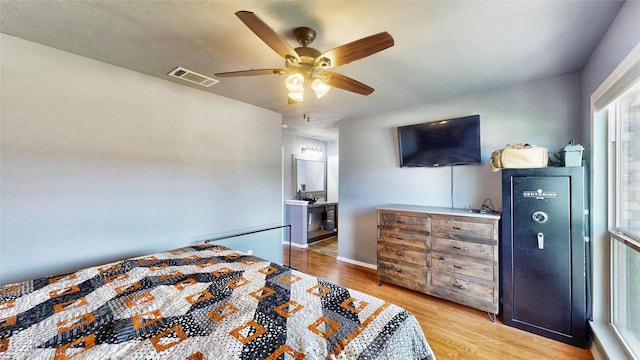 7409 Pebble Beach Dr, Rowlett, TX 75088 - bedroom with wood finished floors, ceiling fan, baseboards, and connected bathroom