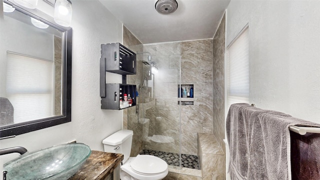 7409 Pebble Beach Dr, Rowlett, TX 75088 - full bathroom featuring toilet, tiled shower, a textured wall, and vanity