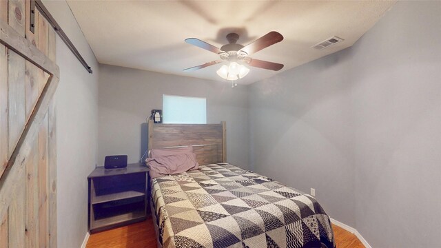 7409 Pebble Beach Dr, Rowlett, TX 75088 - bedroom featuring wood finished floors, baseboards, and a ceiling fan