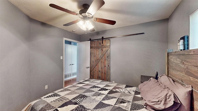 7409 Pebble Beach Dr, Rowlett, TX 75088 - bedroom featuring a barn door and ceiling fan