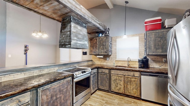 7409 Pebble Beach Dr, Rowlett, TX 75088 - kitchen featuring stainless steel appliances, a sink, light wood-style floors, tasteful backsplash, and hanging light fixtures