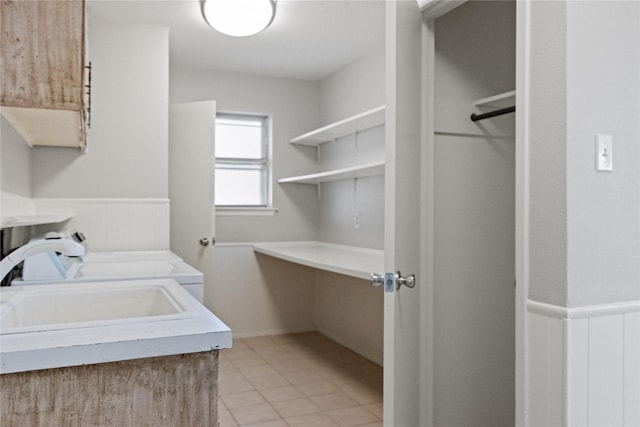 7636 Skylake Dr, Fort Worth, TX 76179 - washroom with light tile patterned flooring, cabinet space, and wainscoting