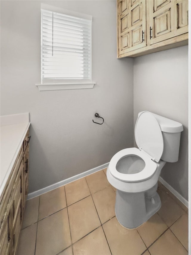 7636 Skylake Dr, Fort Worth, TX 76179 - half bathroom featuring toilet, vanity, baseboards, and tile patterned floors