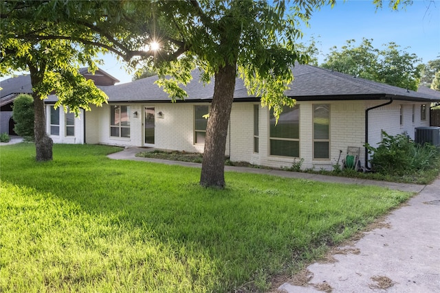 7636 Skylake Dr, Fort Worth, TX 76179 - ranch-style home featuring central AC unit, brick siding, a front lawn, and roof with shingles