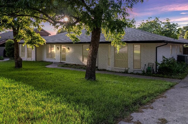 7636 Skylake Dr, Fort Worth, TX 76179 - view of front of property with a front lawn, cooling unit, brick siding, and roof with shingles