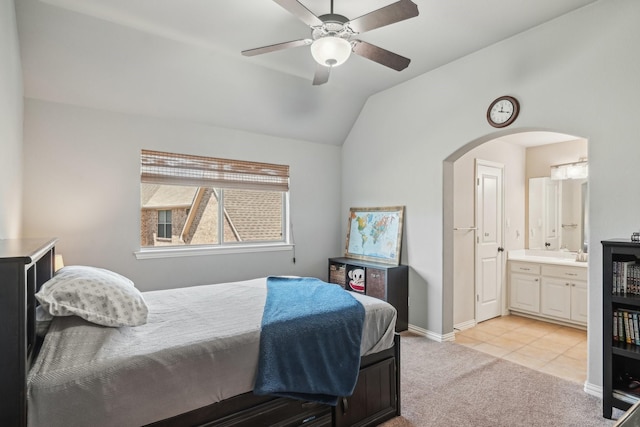5594 Beacon Hill Dr, Frisco, TX 75036 - bedroom with arched walkways, light carpet, vaulted ceiling, ensuite bathroom, and baseboards