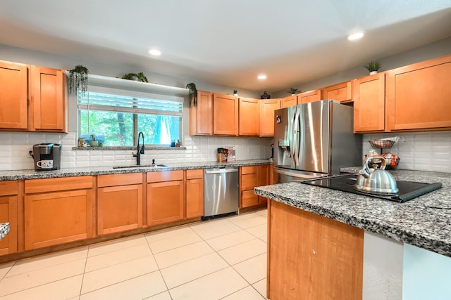 9613 County Road 4091, Scurry, TX 75158 - kitchen featuring a sink, stainless steel appliances, tasteful backsplash, dark stone counters, and light tile patterned floors