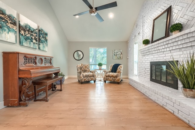9613 County Road 4091, Scurry, TX 75158 - living area with a ceiling fan, wood finished floors, high vaulted ceiling, a brick fireplace, and baseboards