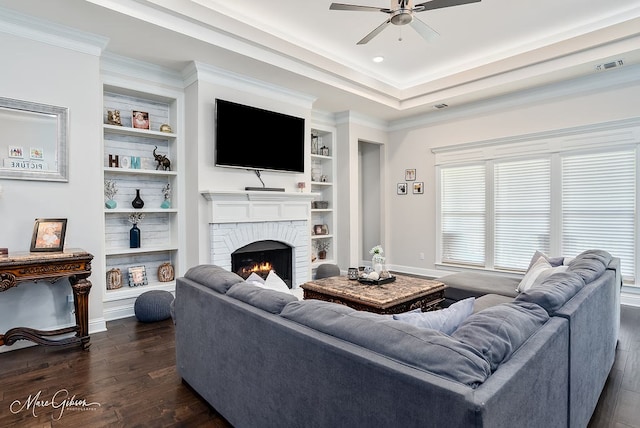 606 Labarre Ln, Bossier City, LA 71111 - living room featuring dark wood finished floors, a ceiling fan, built in features, a fireplace, and ornamental molding