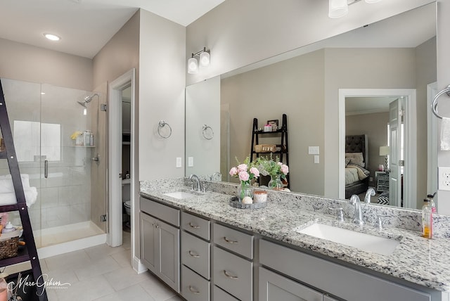 606 Labarre Ln, Bossier City, LA 71111 - full bathroom featuring ensuite bathroom, toilet, double vanity, a shower stall, and tile patterned flooring